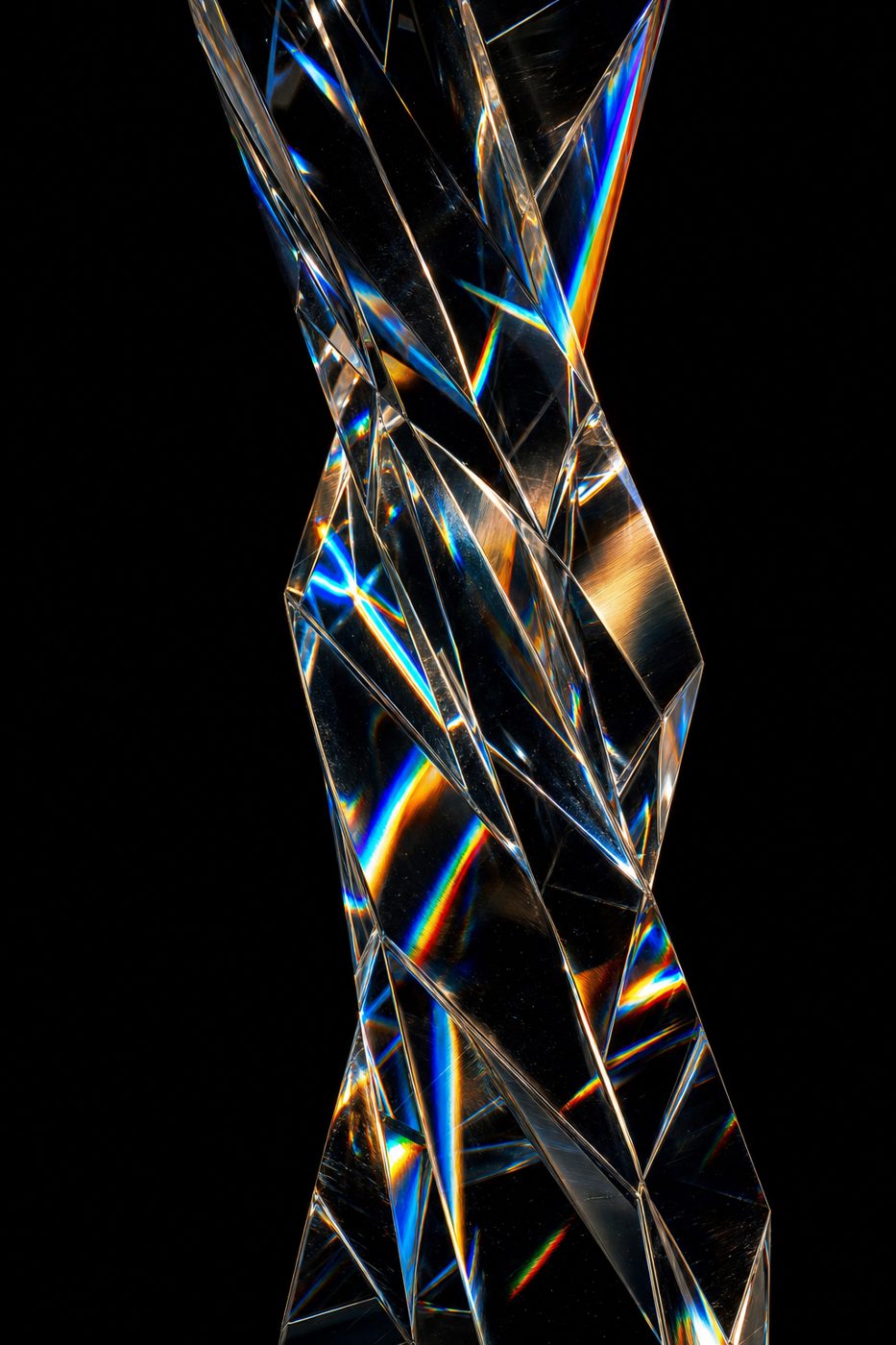 Twisted glass prism refracting champagne and blue light
